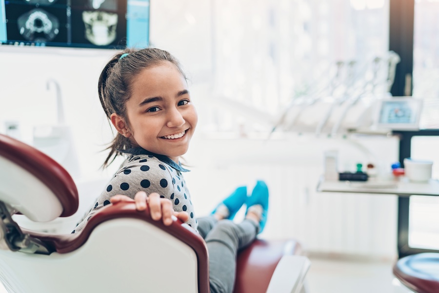 girl at dental office for fluoride treatment