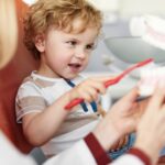 young boy at dentist for common dental services for kids in pediatric dentistry