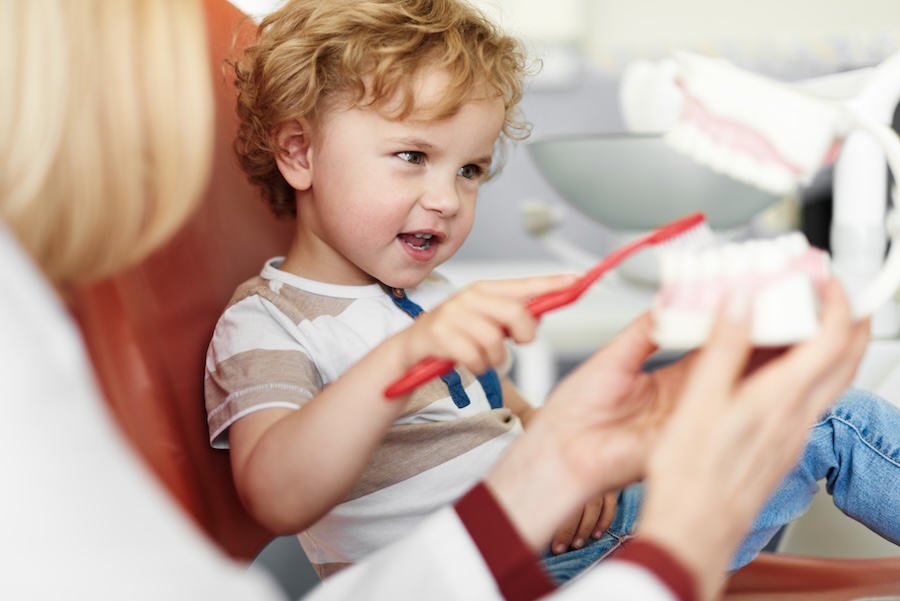 young boy at dentist for common dental services for kids in pediatric dentistry