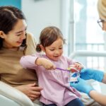 child at dentist for dental cleaning and exam