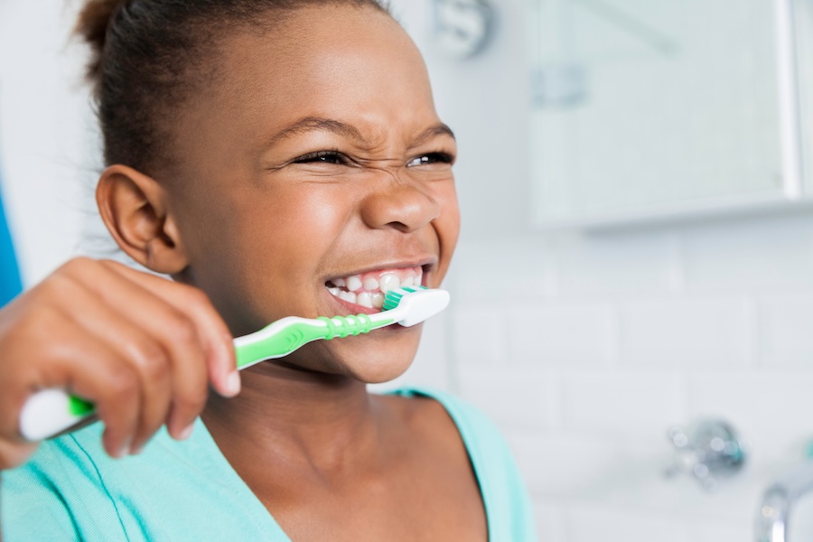 young girl brushing her teeth, how to motivate kids to brush teeth