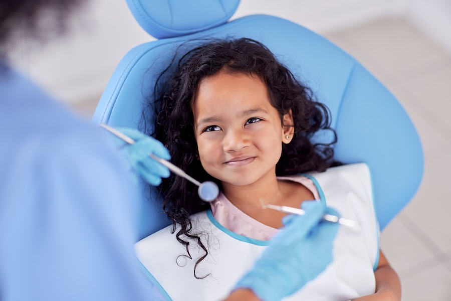 girl getting dental work, pediatric dental crown covered by insurance